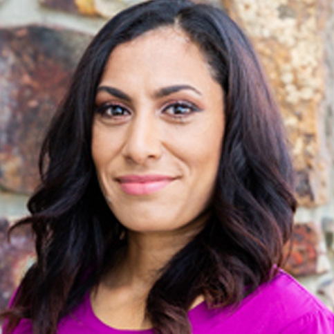 boardofdirectors—Vanessa-Cadena A woman with long hair wearing a purple shirt.