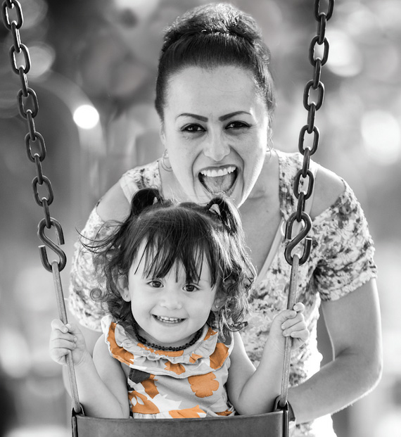 A woman and child on a swing.